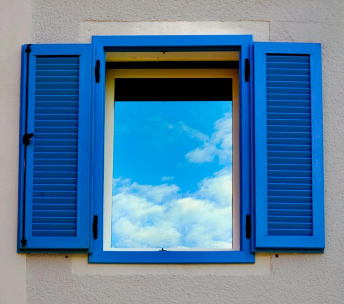 a window with blue shutters and the sky as background