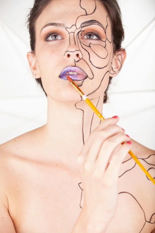 a woman with a pencil in her mouth