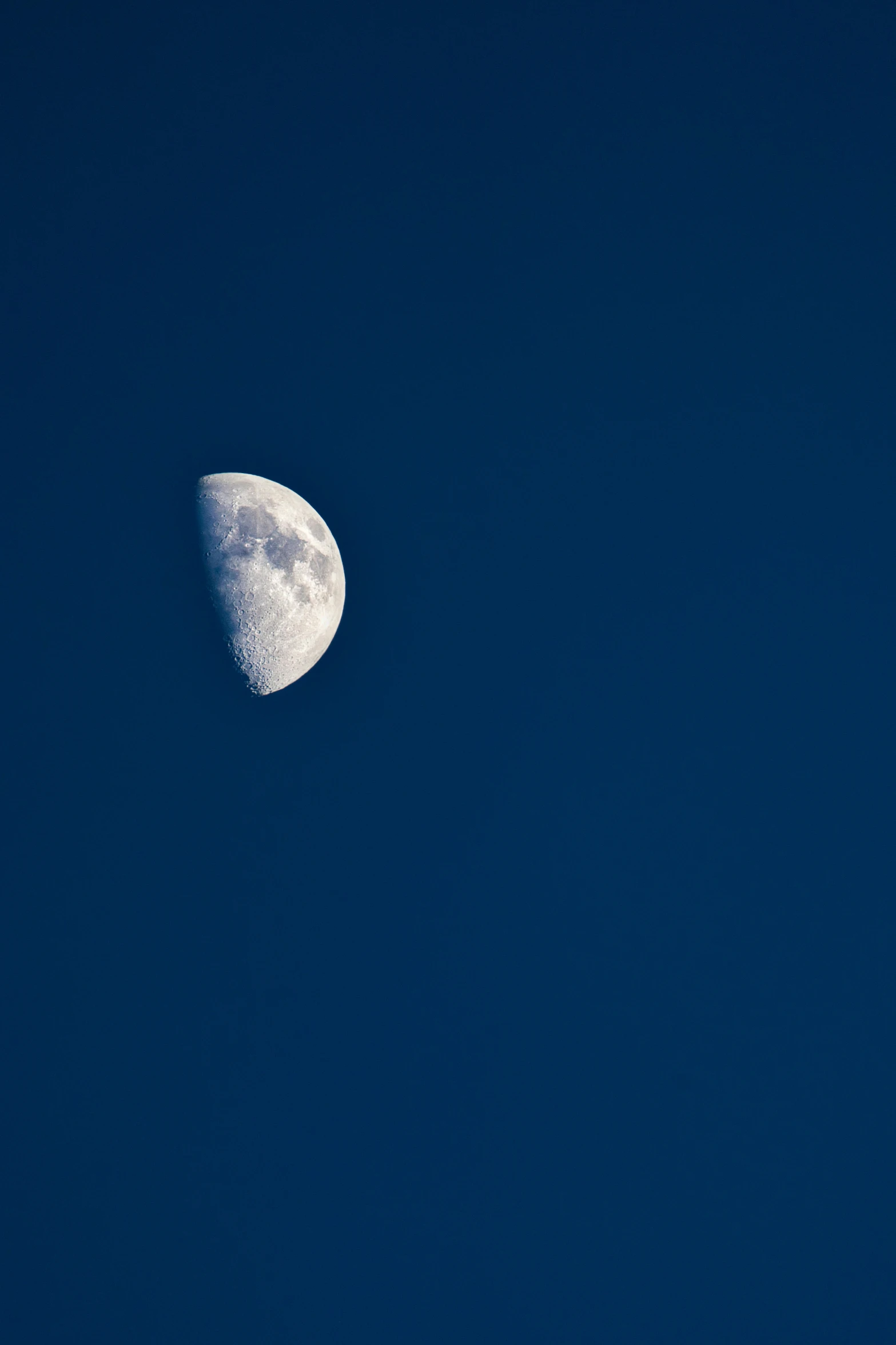 a crescented object is visible above the clear blue sky