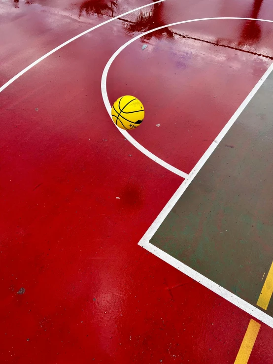 a basketball that is on the floor of a gymnasium