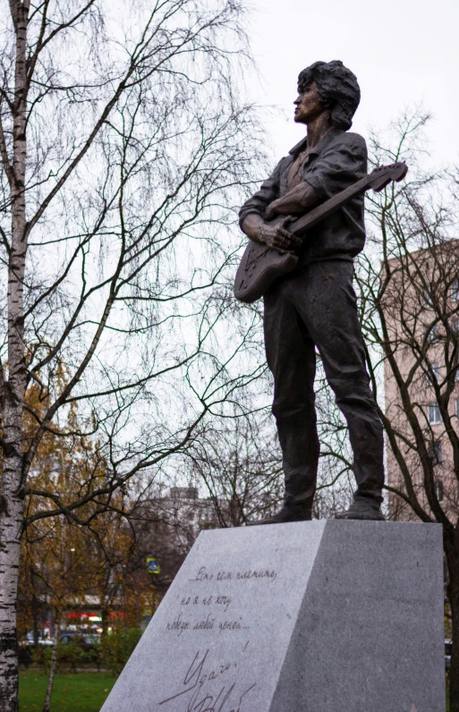 a statue of a man holding a guitar