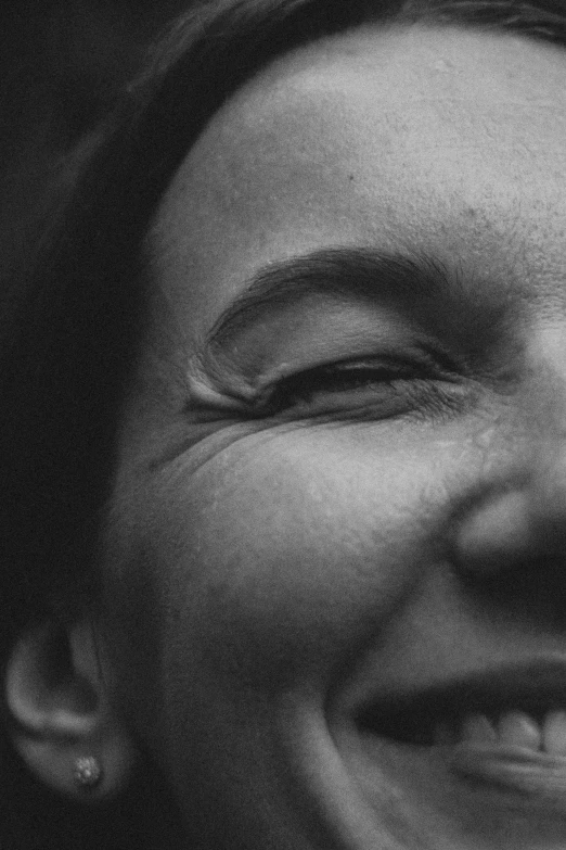 a black and white pograph of a smiling woman