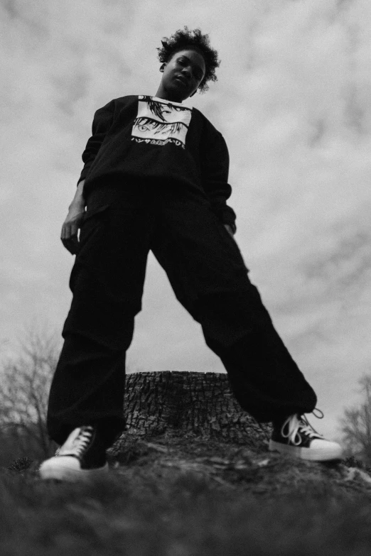 a young woman is leaning up against a rock