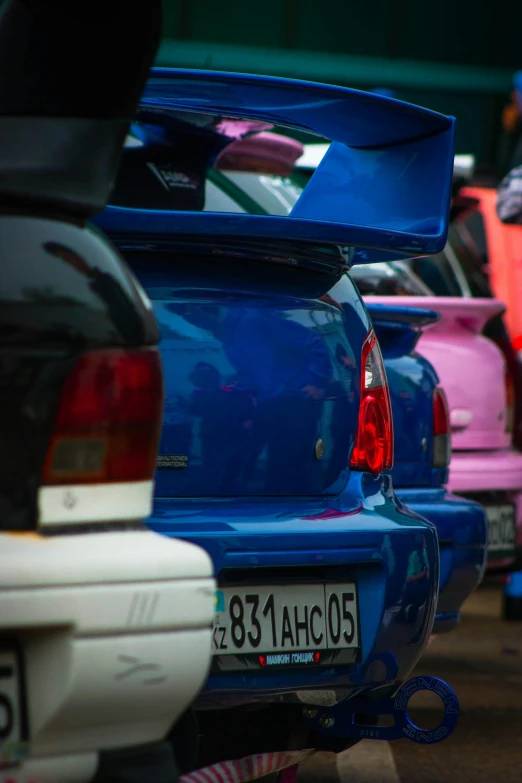 a car parked in the parking lot of an automobile shop