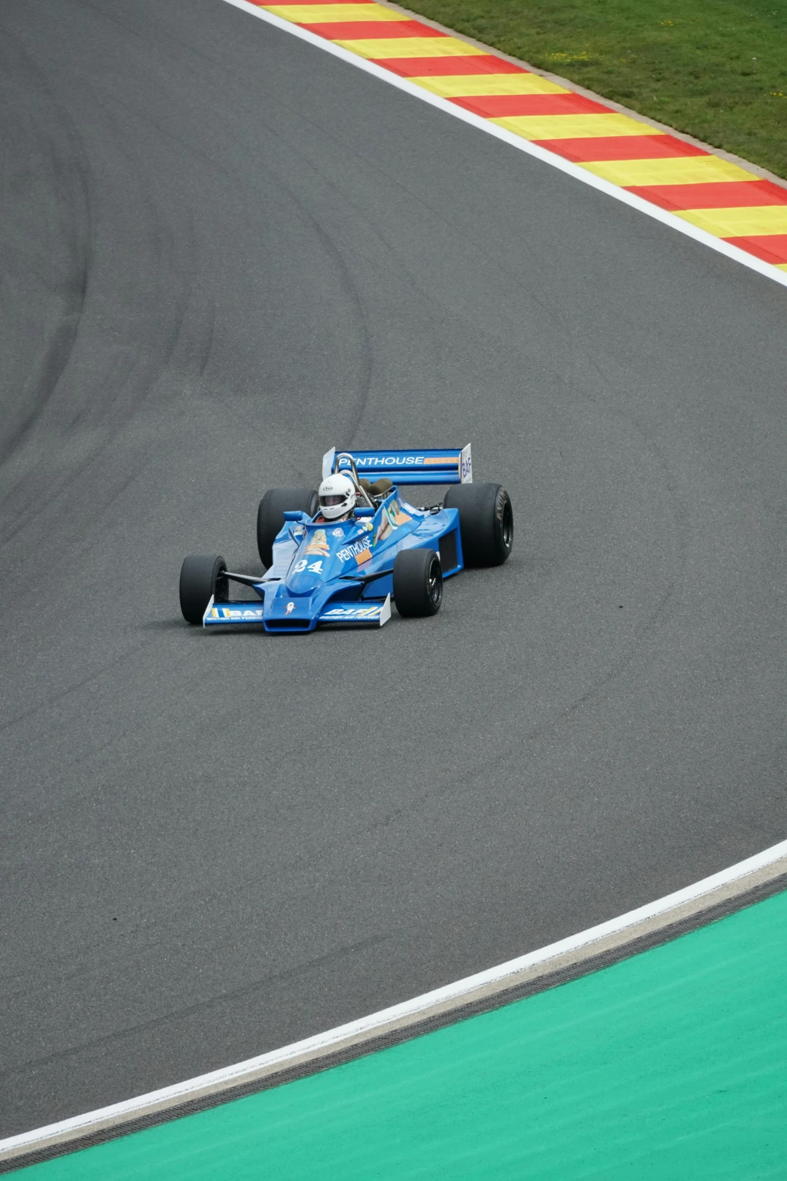 a blue race car in the middle of a race