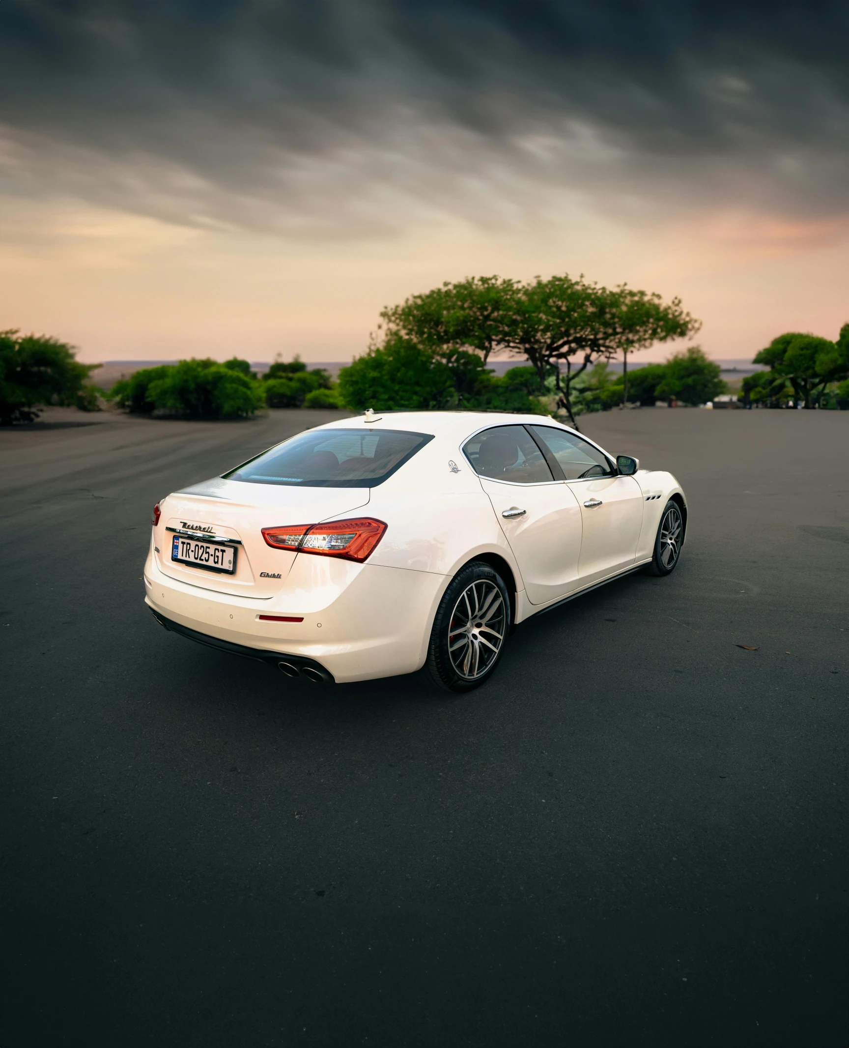 white car parked on asphalt in urban setting