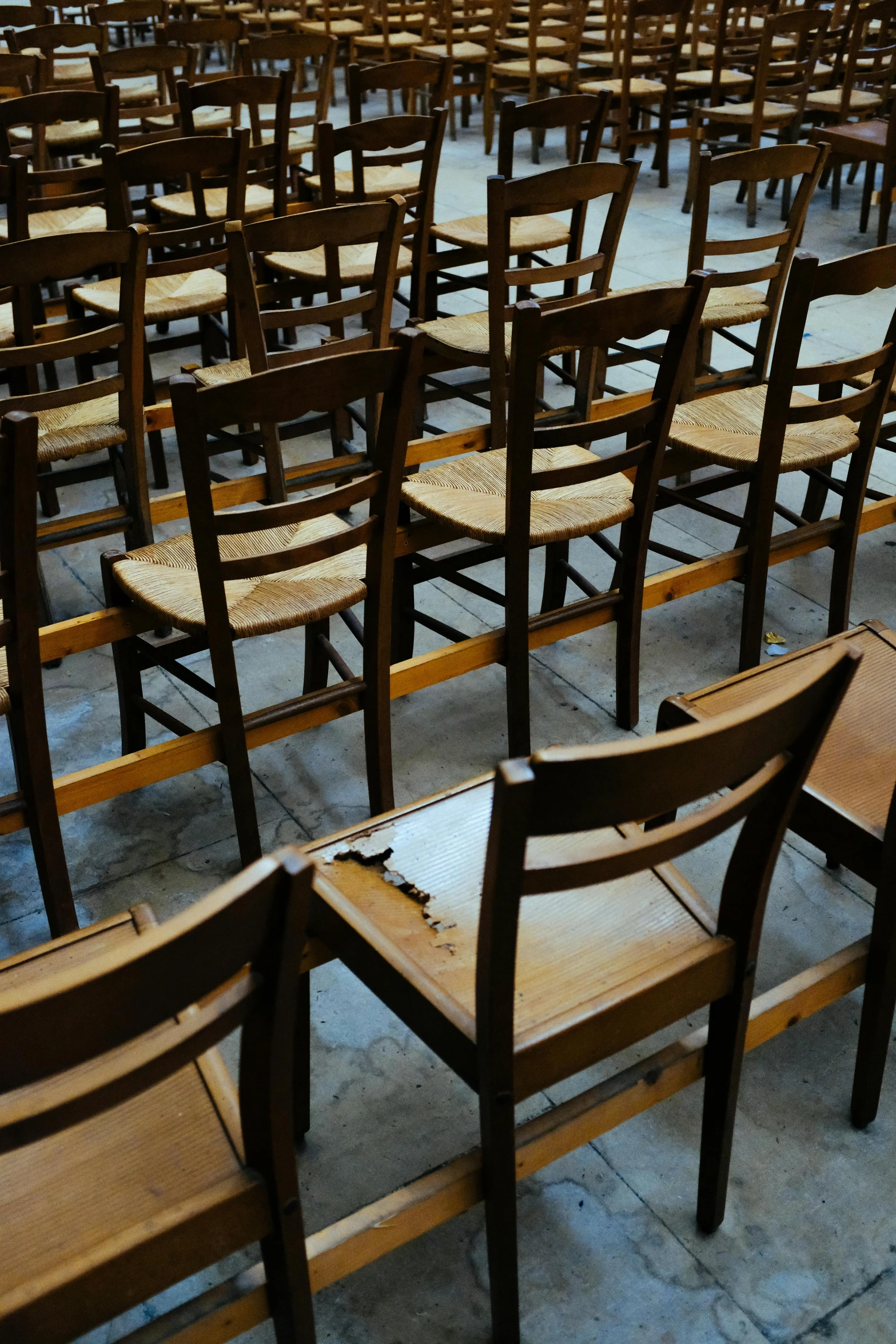 some old wooden chairs sitting together