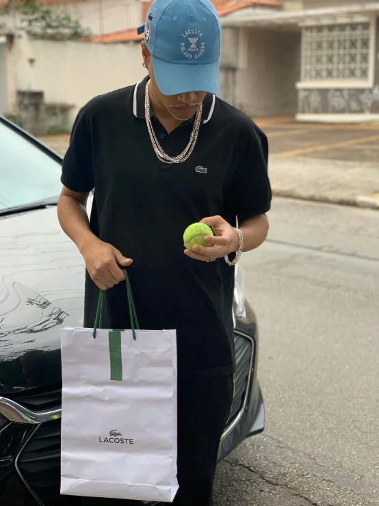 a man holding an apple and a white shopping bag