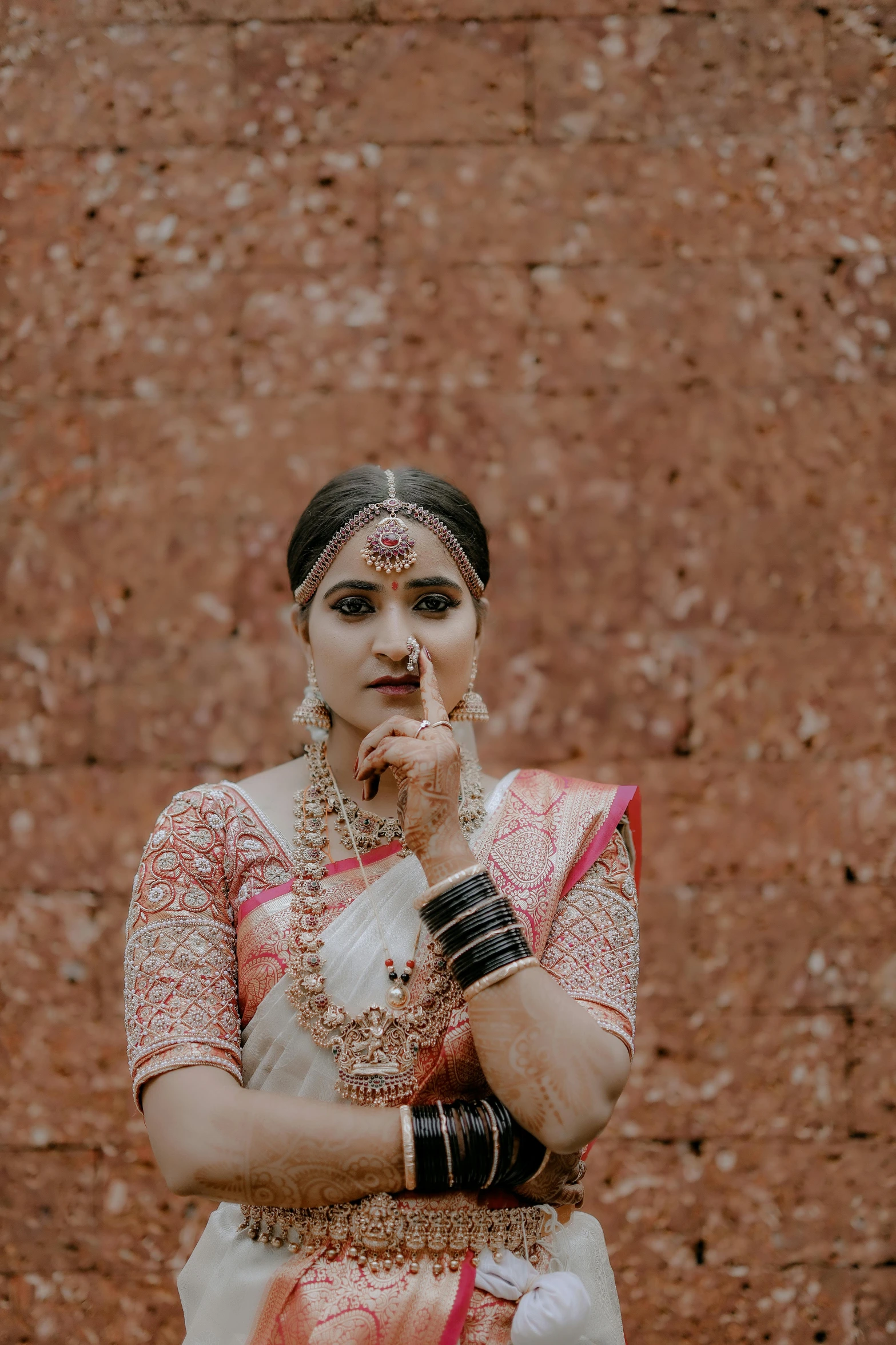 an indian woman standing in front of a wall