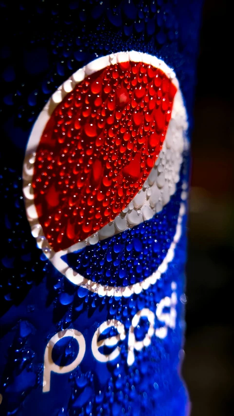 a bottle of pepsi soda that has been half - opened and is slightly water - dropied