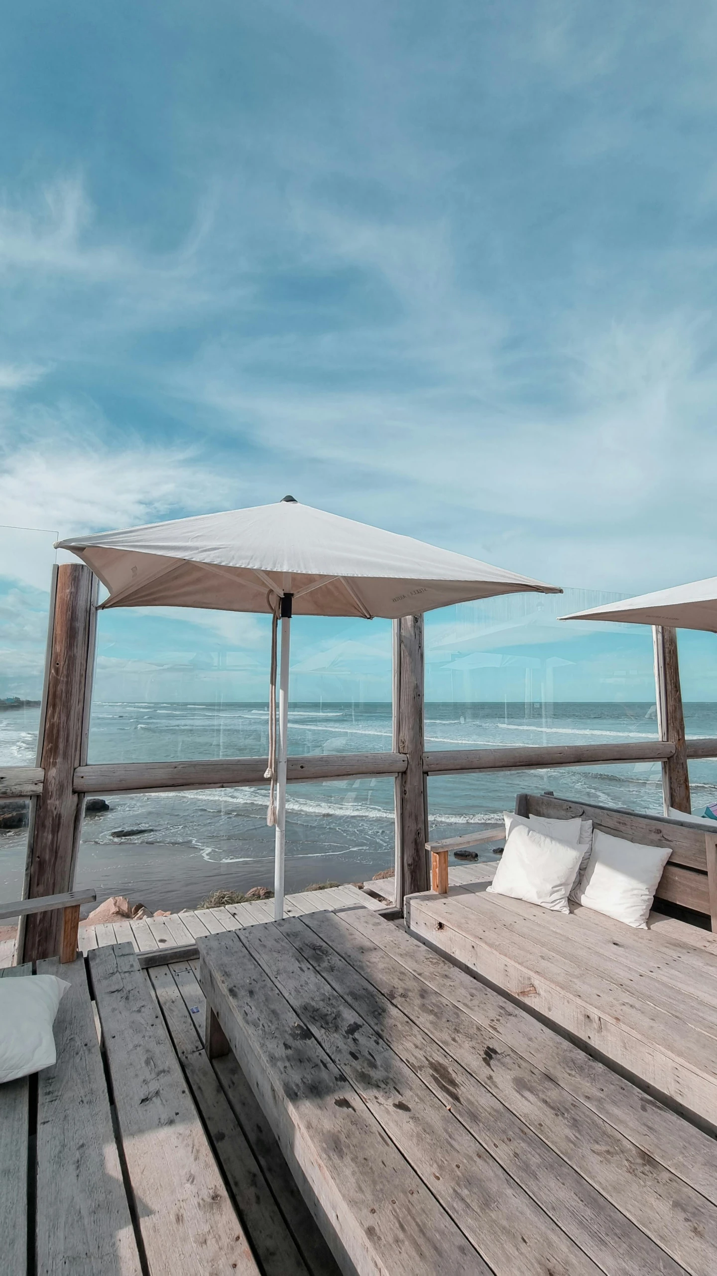 a wooden table on a beach next to a body of water