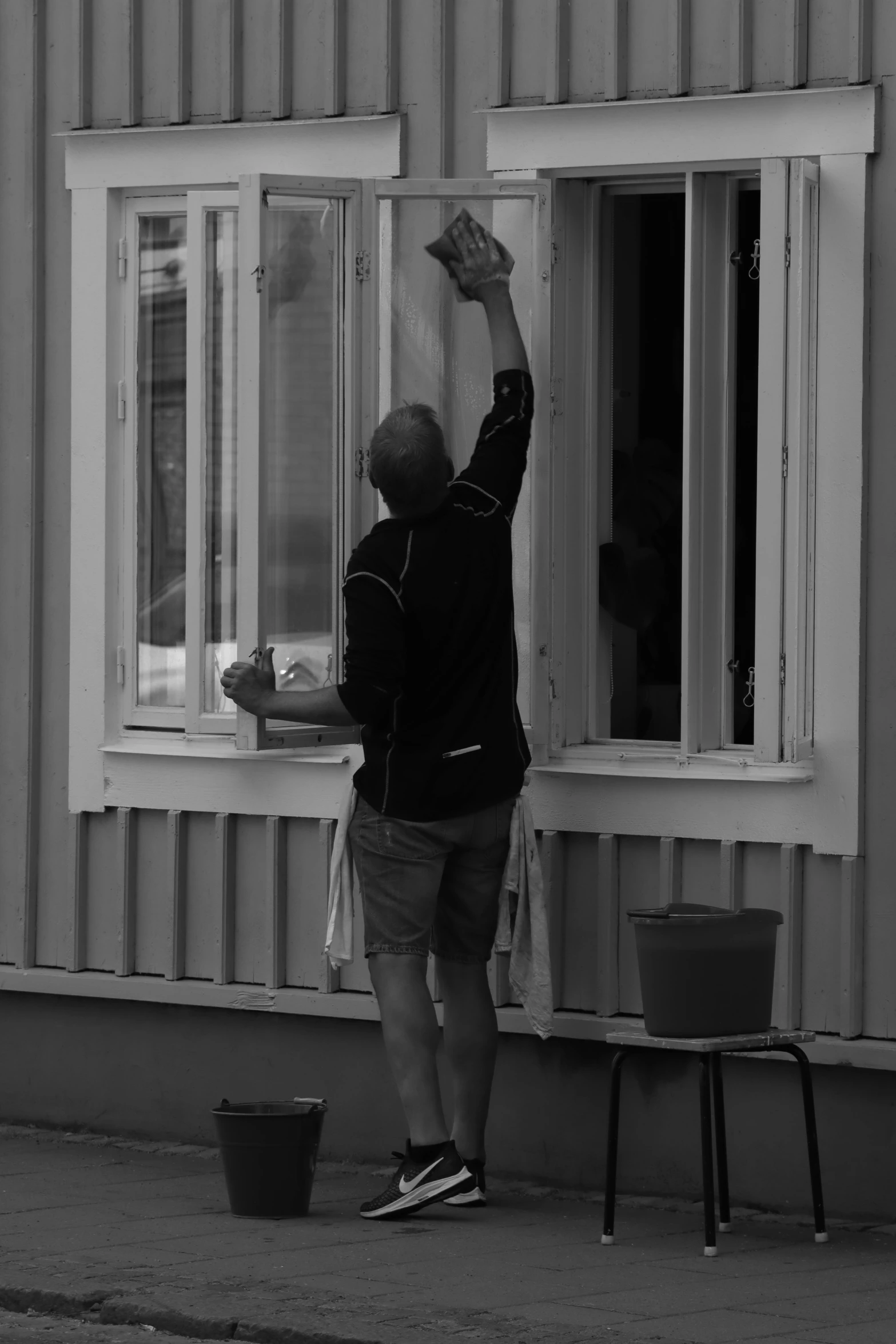 a man with his hands up looking outside of a window