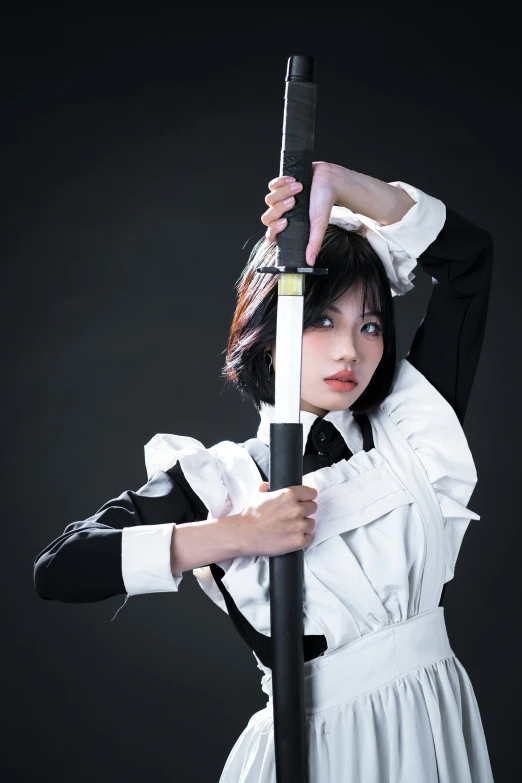 a woman with a sword is standing on a black background