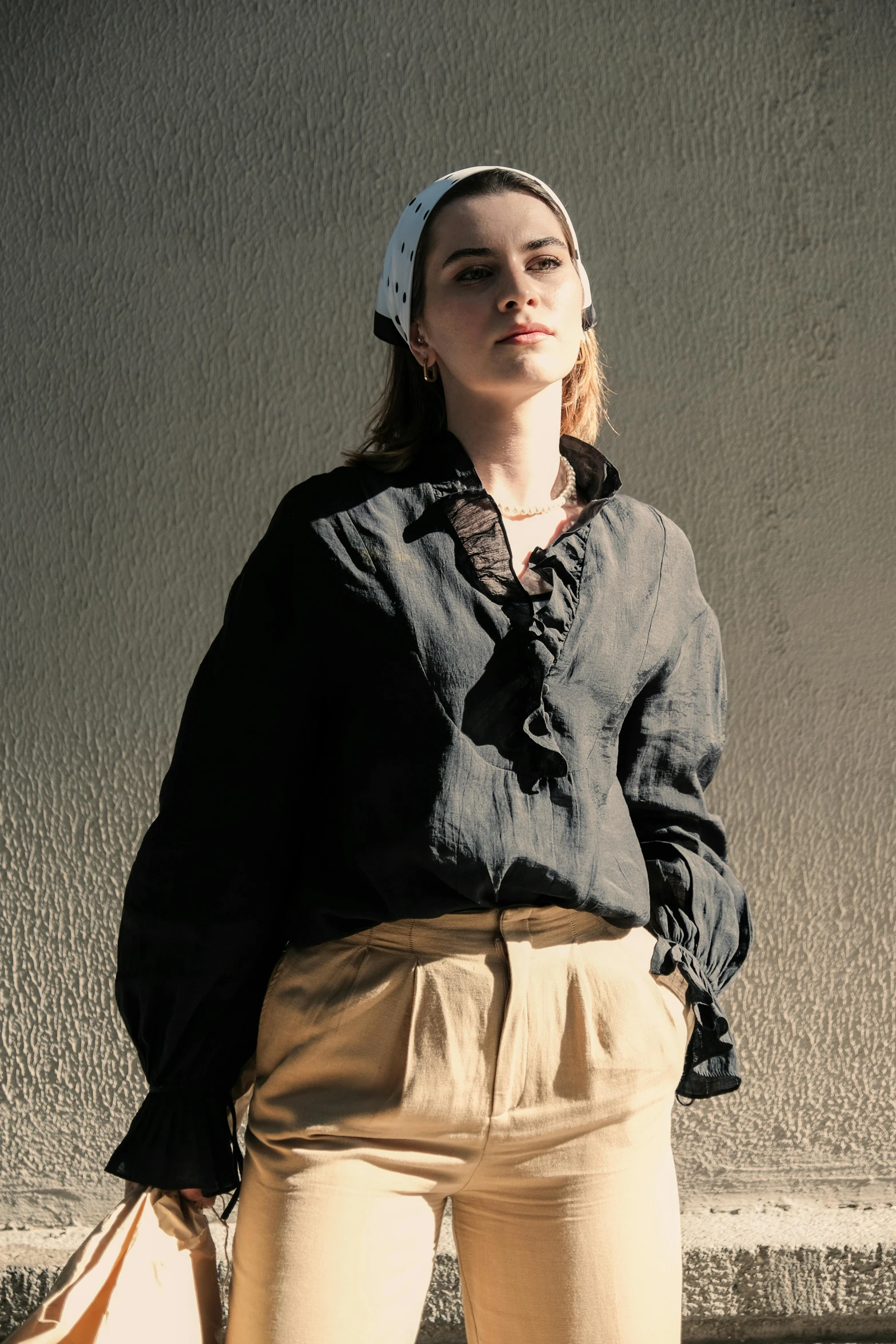 a woman is standing outside near the concrete