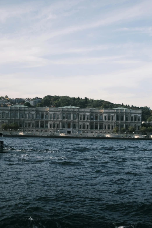 a boat is sailing past a large castle near the water