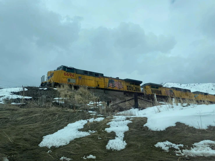 an image of a train traveling on the track in the snow