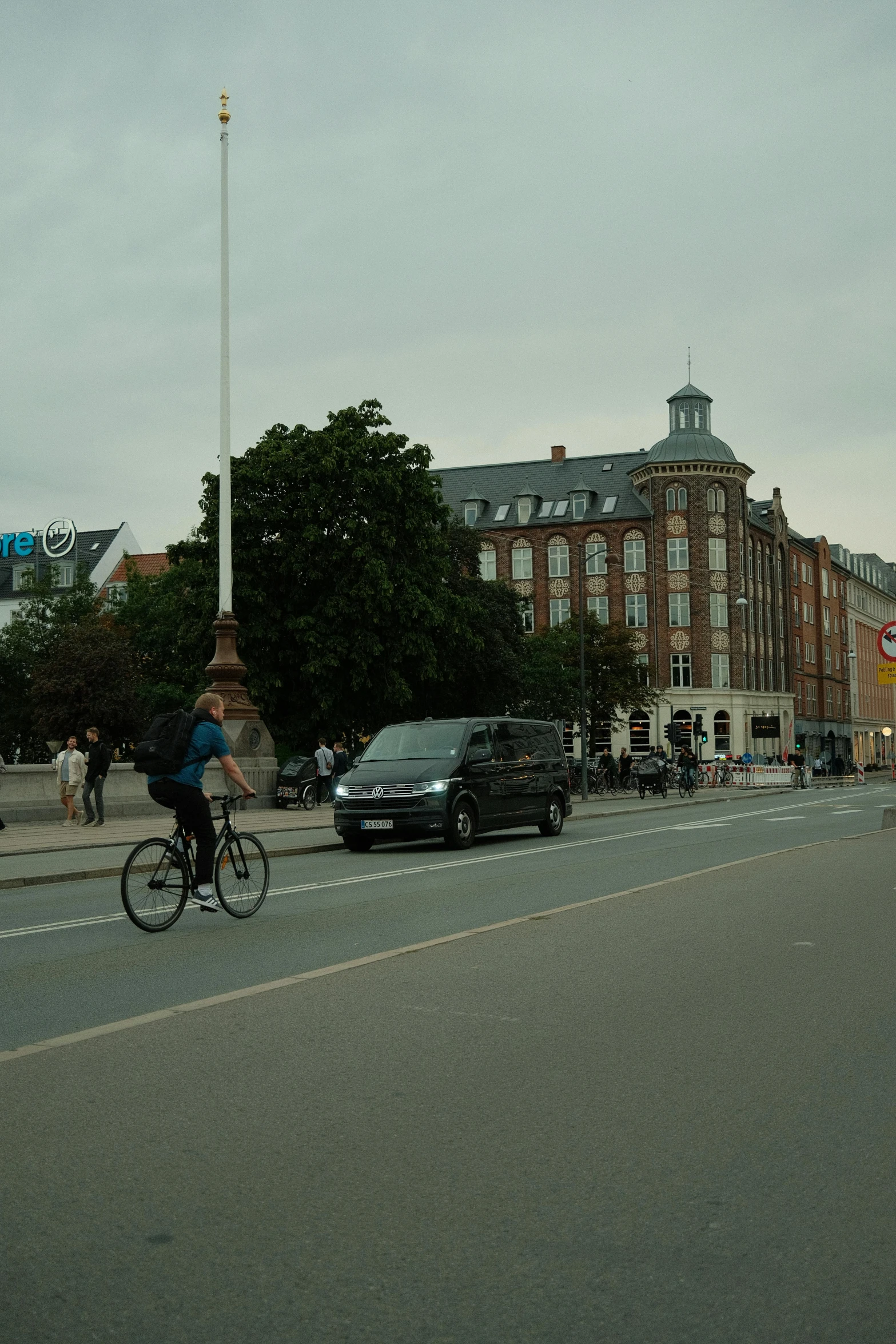 a man riding his bike down a city street