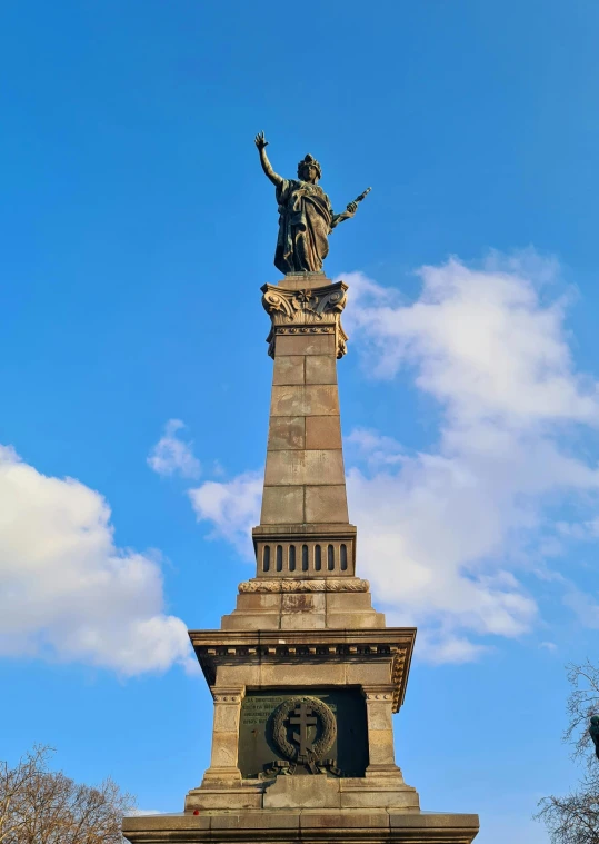 the statue of liberty stands tall in front of a cloudless sky