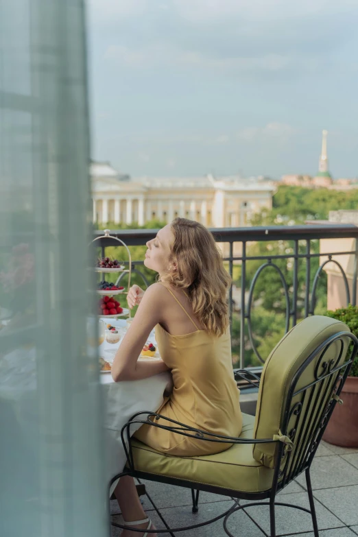 a woman sitting at a table on the balcony