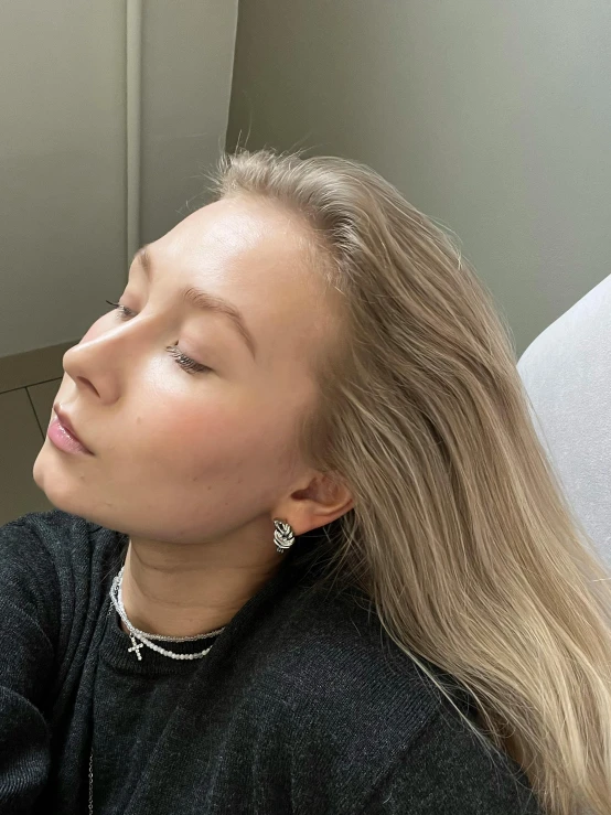 a woman laying down with her head resting on her arm