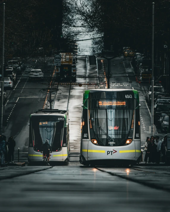 two buses are parked on the side of the road