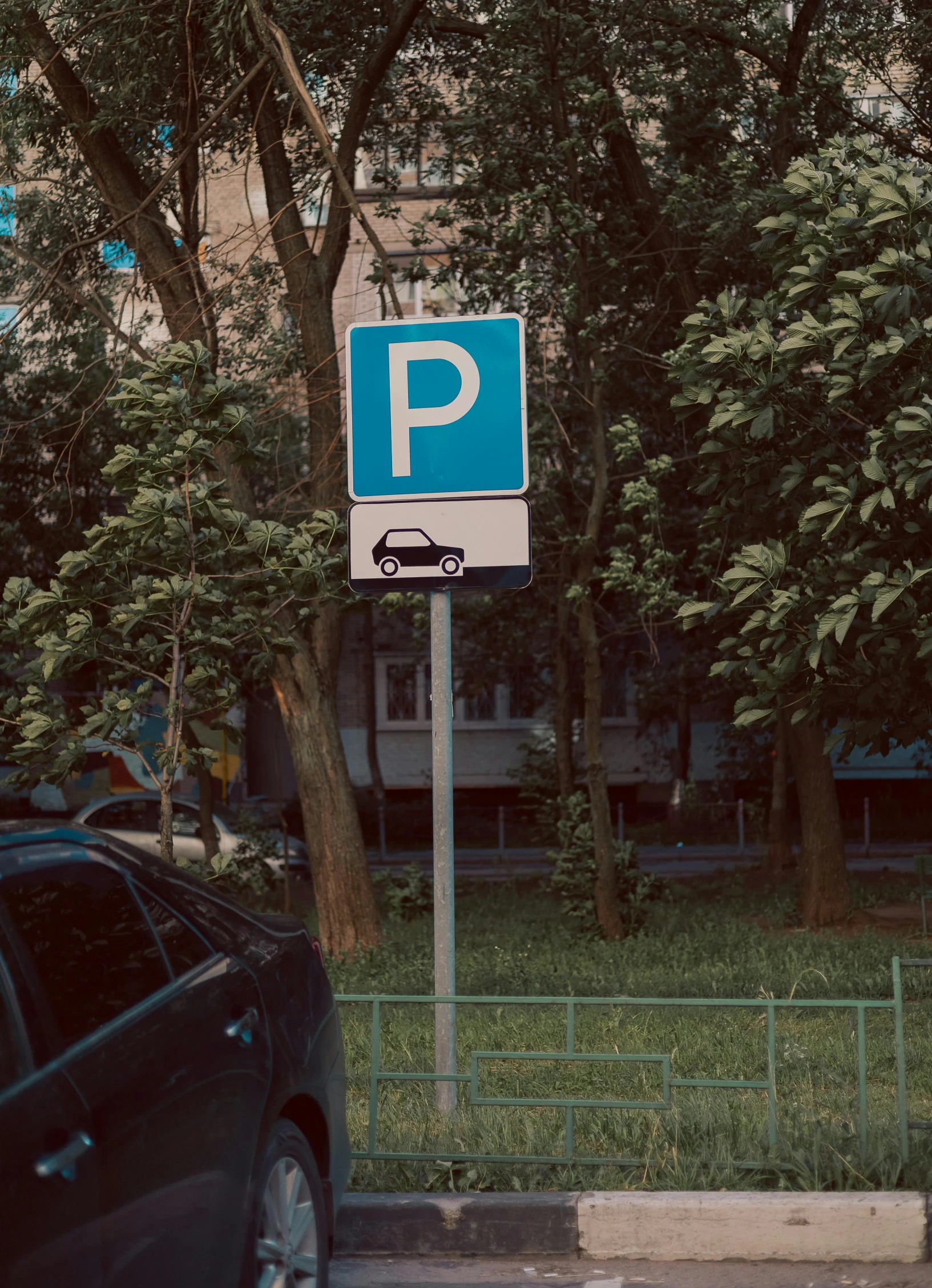 an image of a car driving past parking signs