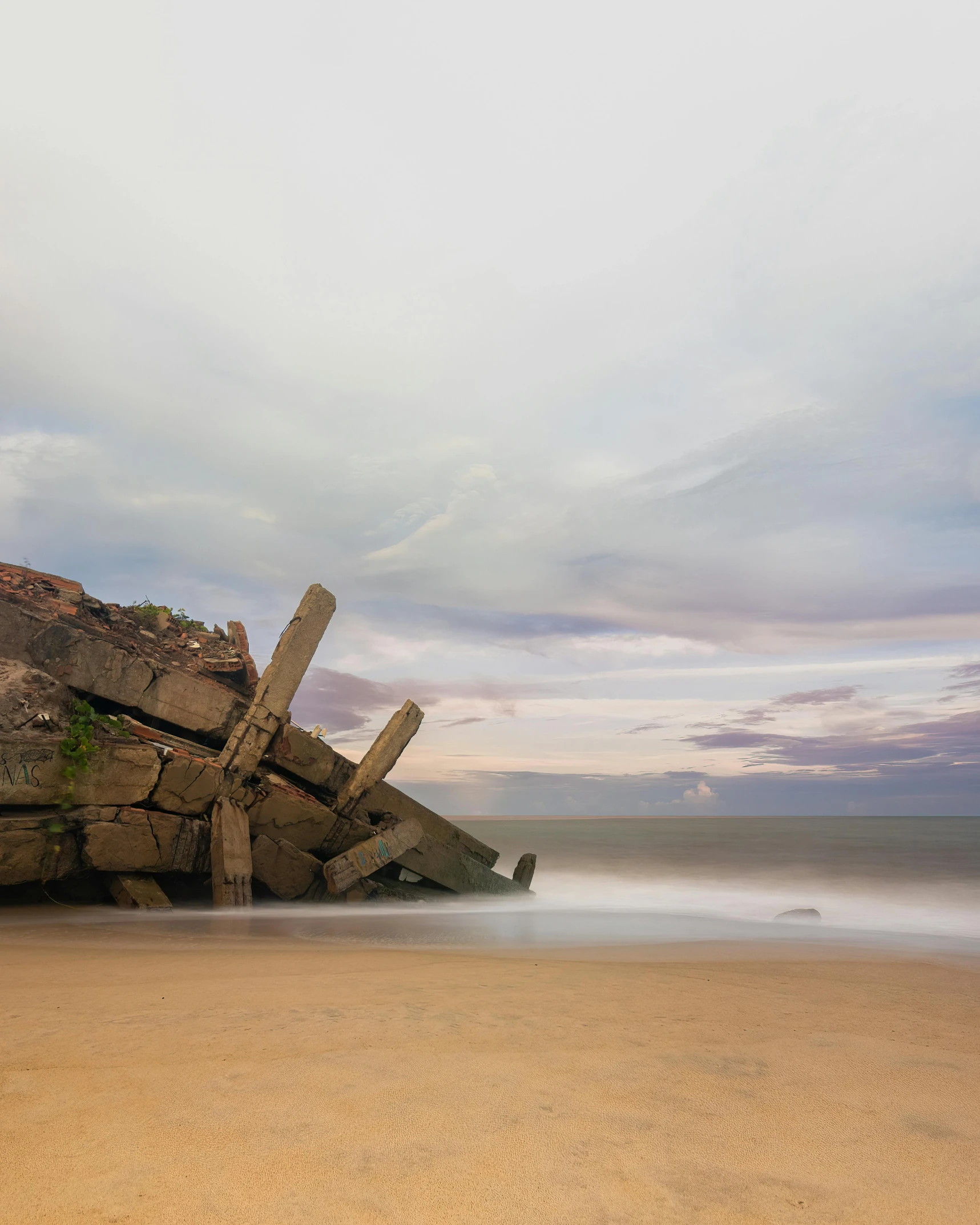 a small rocky shore on a deserted beach