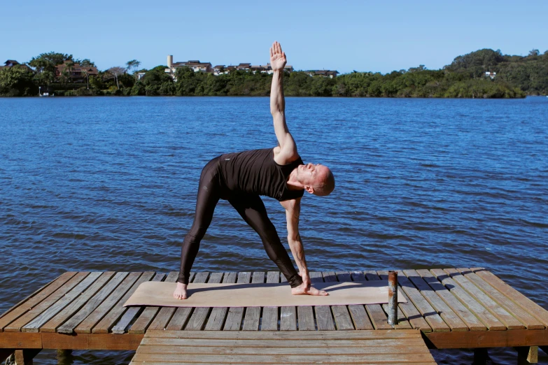 a person is doing a yoga on a dock