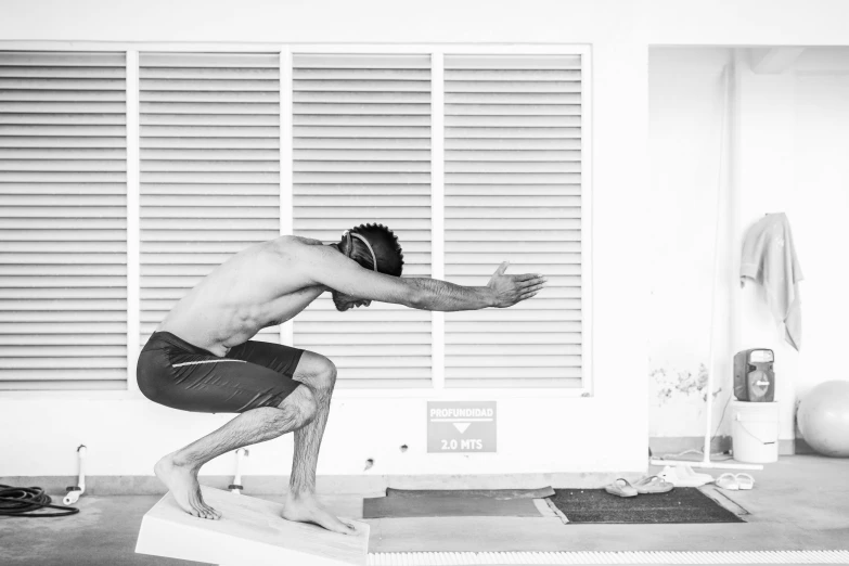 an indian man is performing a yoga pose