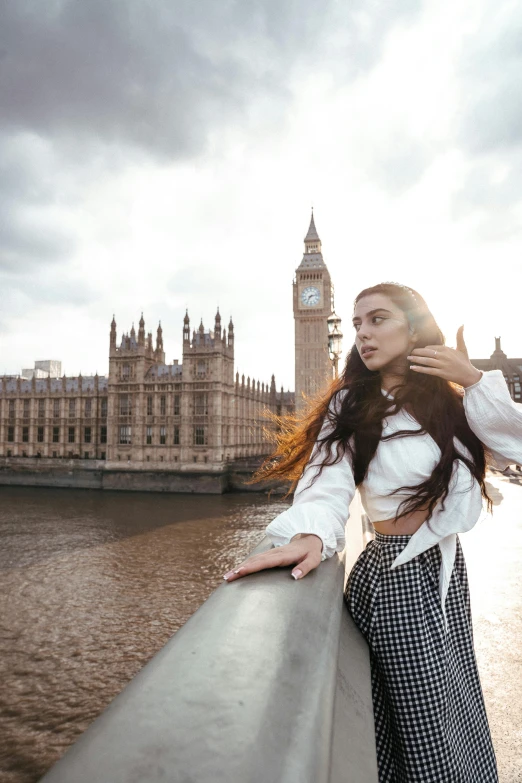 a girl that is standing up against a railing