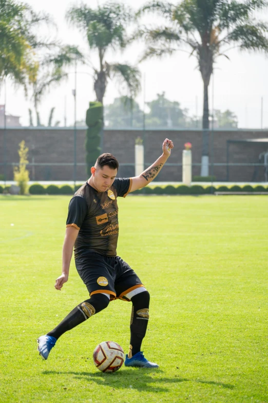 soccer player going after a ball in green field