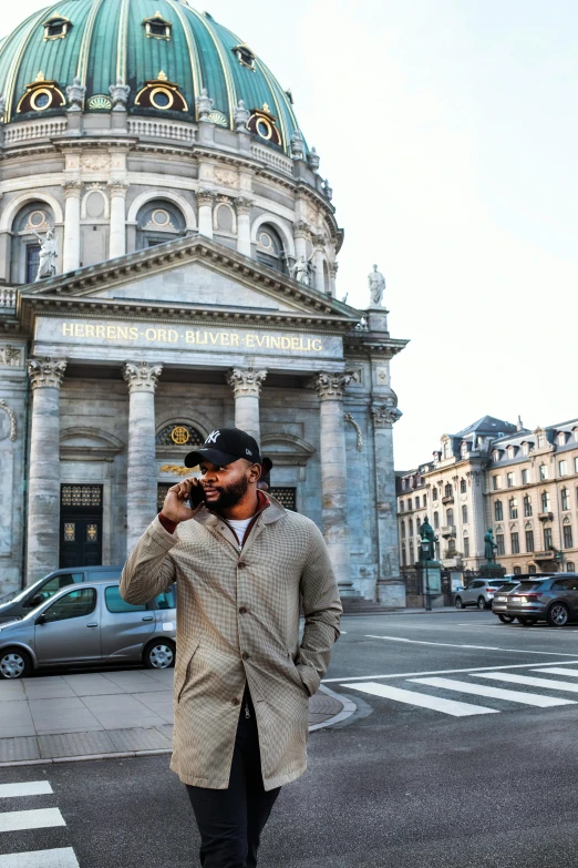 a man is standing on the street taking a picture