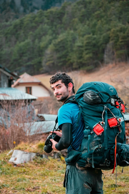 a man with an over sized backpack is in a small area