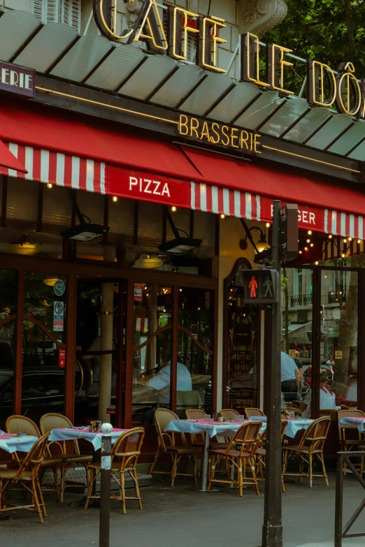 a restaurant with tables and chairs outside of it