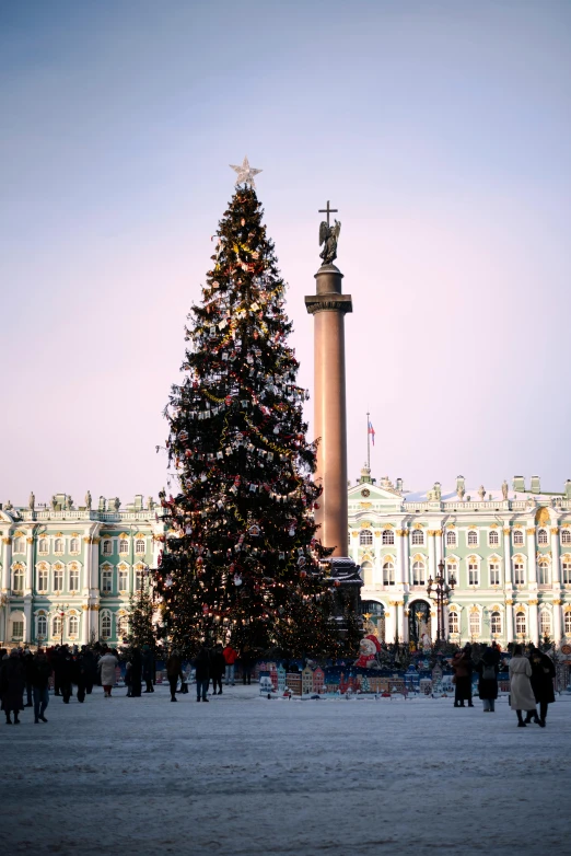 a large decorated christmas tree in front of a building