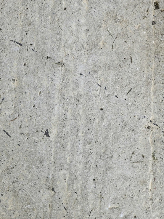 a white marble surface with black and grey dots