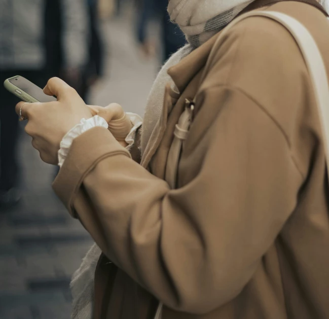 a close up of a woman holding a cell phone