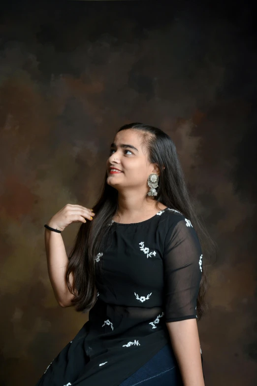 an indian woman smiling and posing for a po