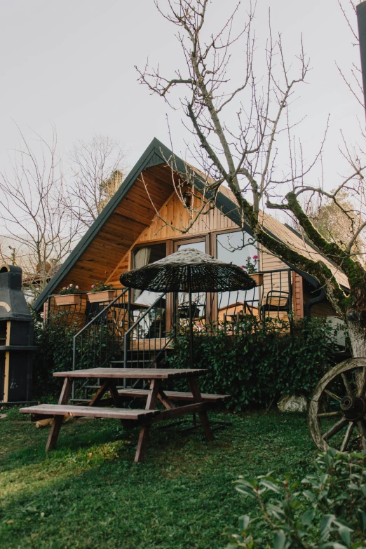 a cabin style home with a picnic table in the yard