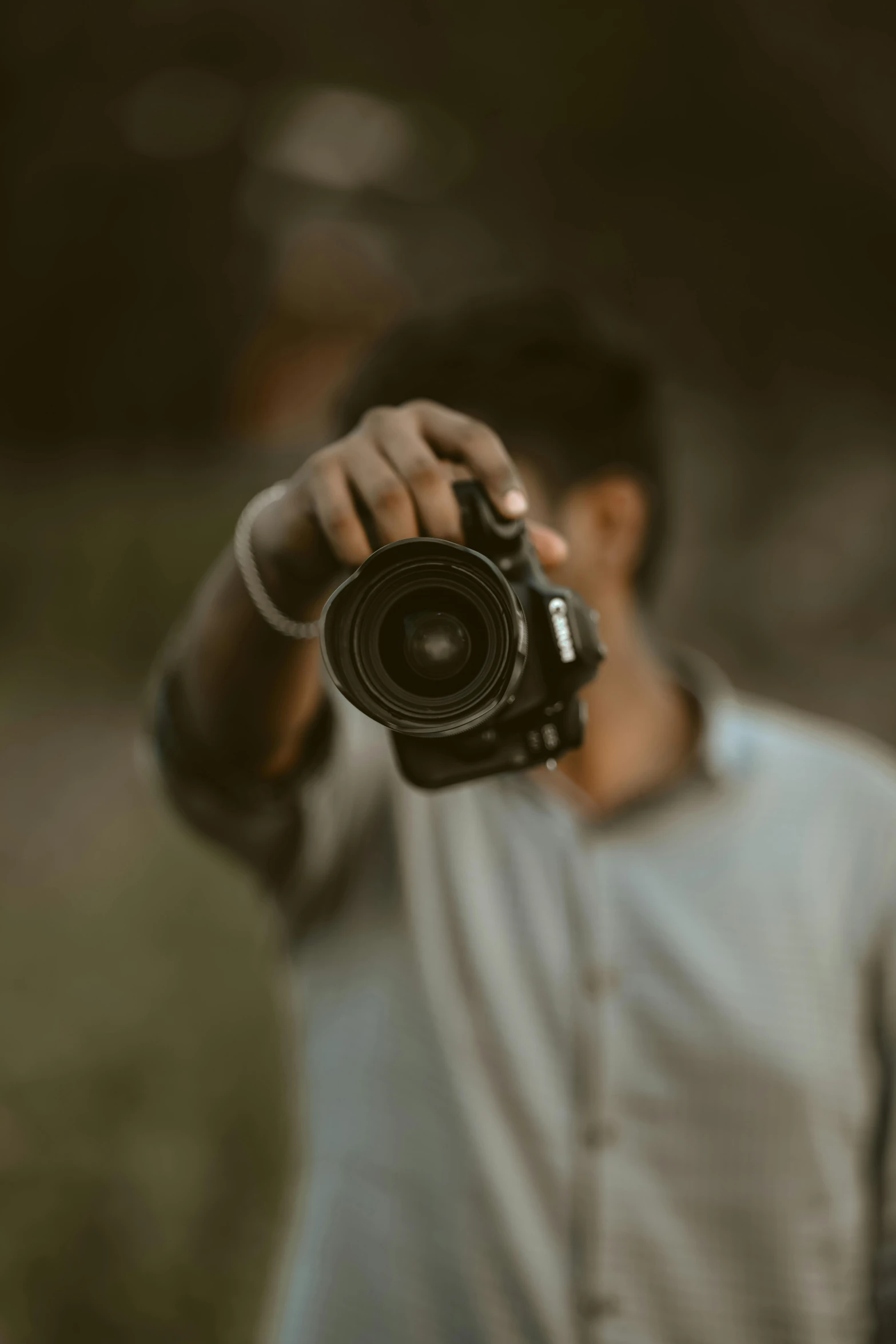 the man is holding up a camera for his image