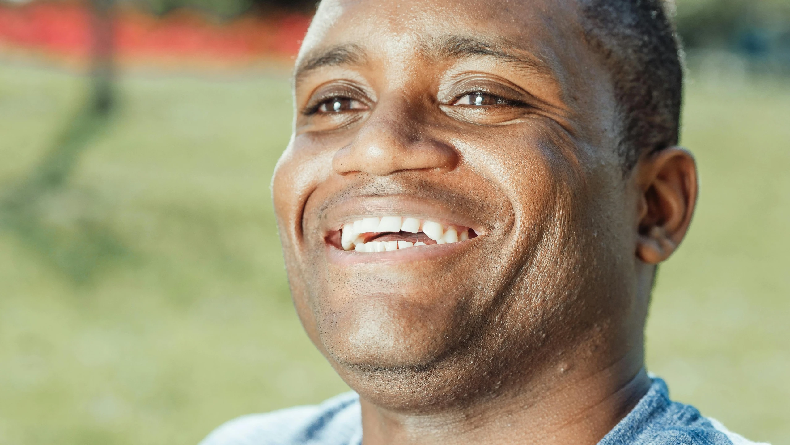 a man with a blue shirt is smiling