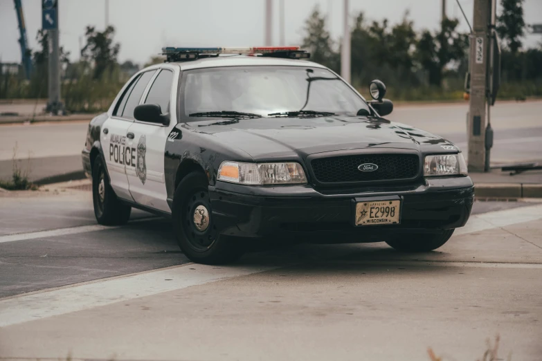 a police car parked at a traffic light