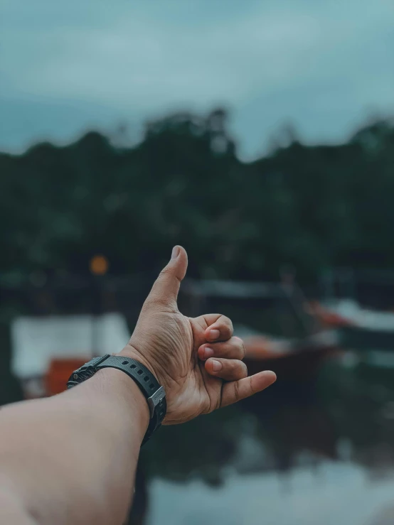 a person is holding their hand up in the air