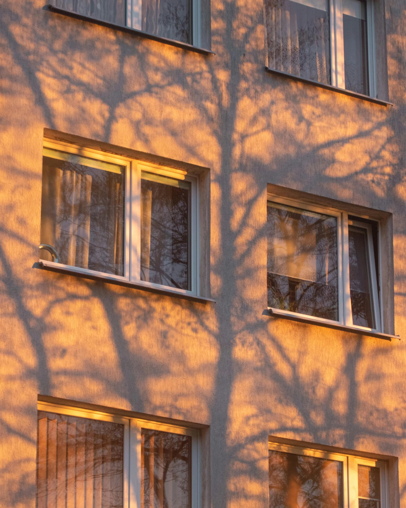 shadows on an apartment building that has three windows