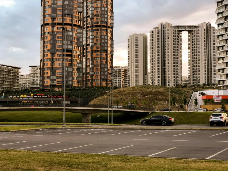 large apartment buildings and parked cars on a street