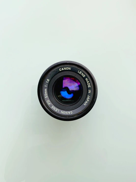 a camera lens mounted on a white wall