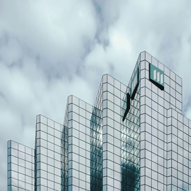 several mirrored buildings that are against the sky