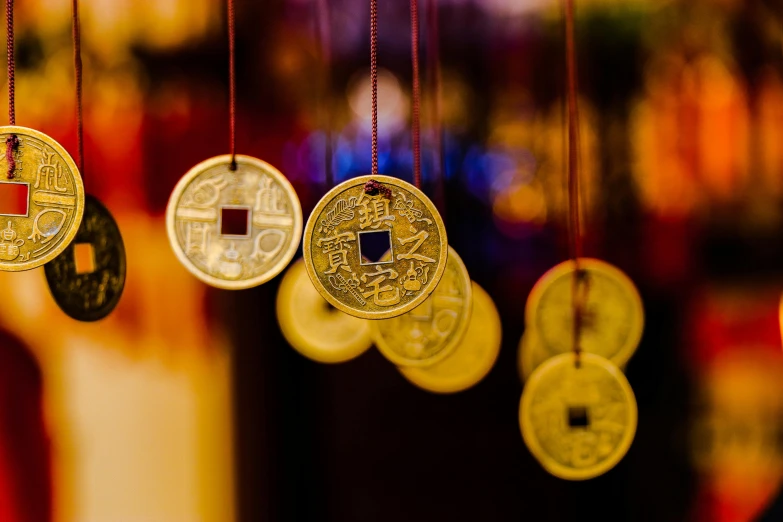 some small gold coins hanging from a line