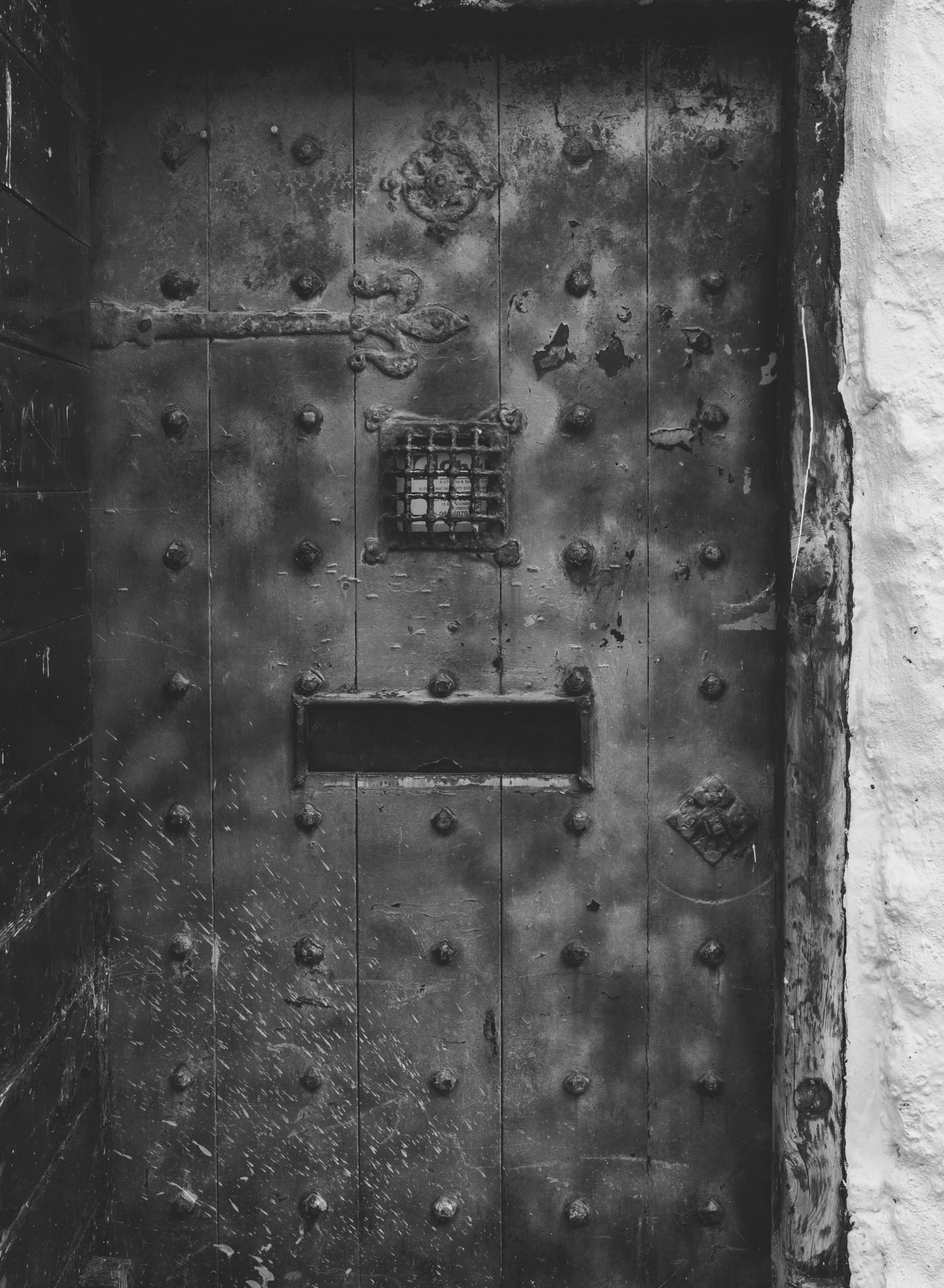 black and white pograph of the door to a prison cell