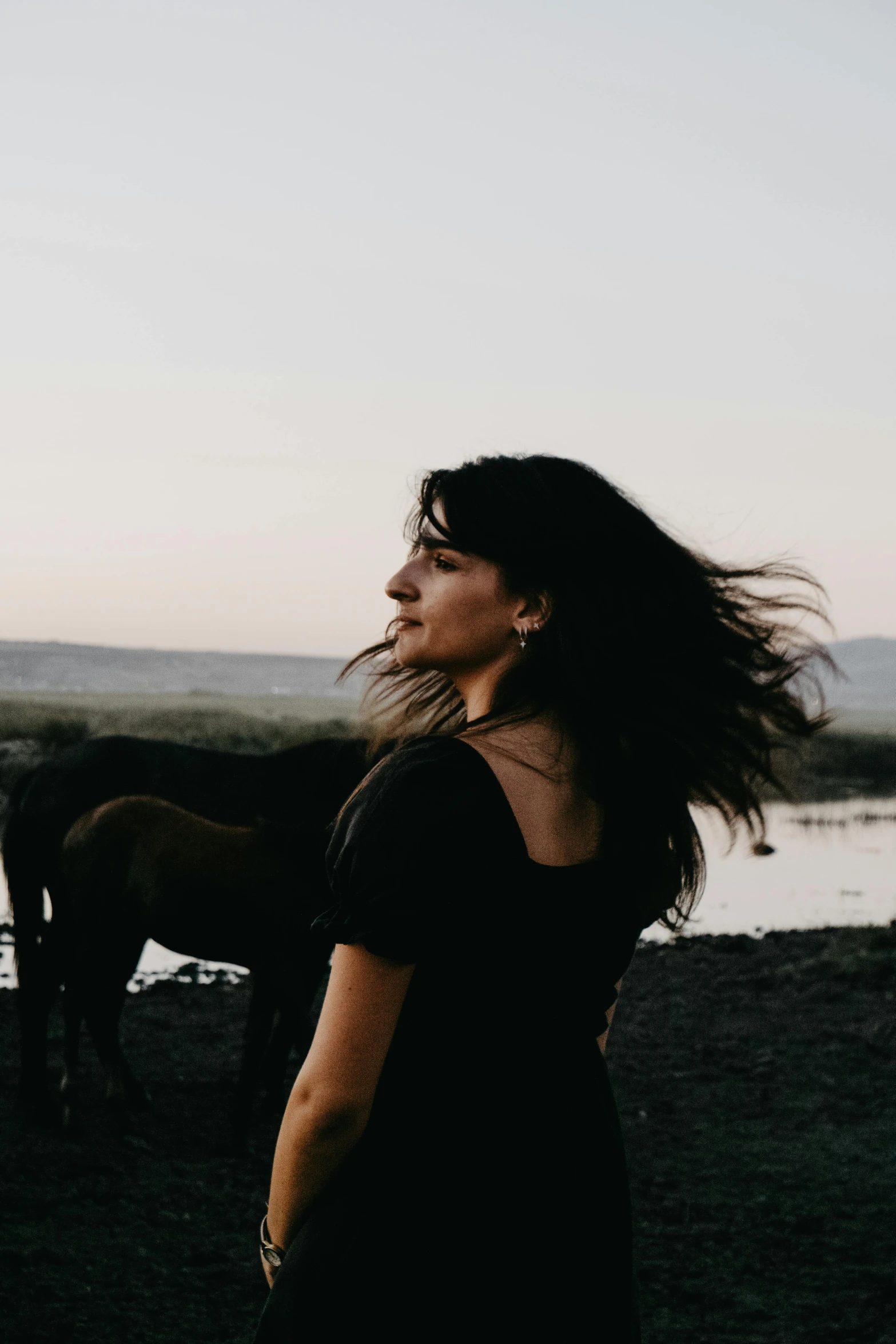 a person is standing next to some horses